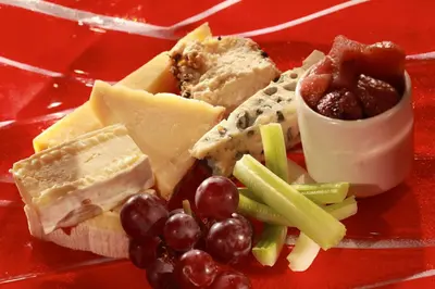 a plate of different types of cheese and grapes at Best Western Plus Dunfermline Crossford Keavil House Hotel in Dunfermline
