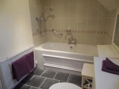 a bathroom with a tub and a toilet and a sink at Robin's Rest in Auchterarder