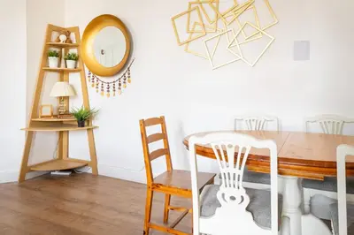 a dining room with a table and a mirror at Bright High-Ceiling 2BD Flat - Central Edinburgh! in Edinburgh