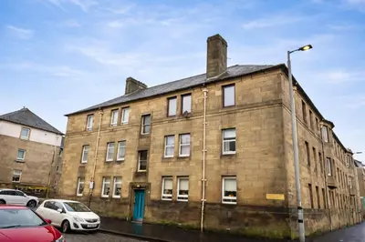 an old brick building with cars parked in front of it at Stylish 2-Bed Apartment in Greenock - Sleeps 6 in Greenock