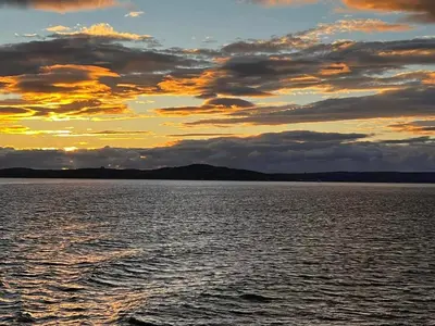 a sunset over a large body of water at Cadillac Kustomz Guest House in Rothesay