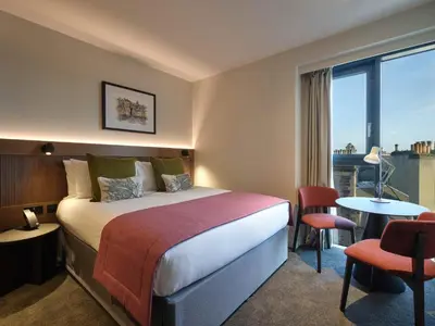 a hotel room with a bed and a table and chairs at The Resident Edinburgh in Edinburgh
