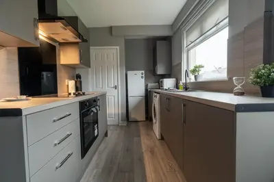 a kitchen with a sink and a counter top at The Bowhouse in Grangemouth