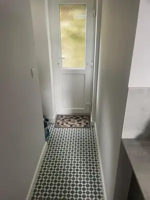 a hallway with a door and a tile floor at Springlea in Oban