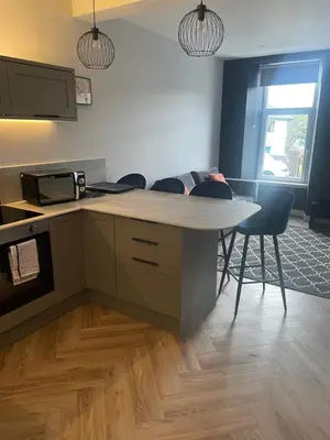 a kitchen with a table and chairs in a room at Springlea in Oban