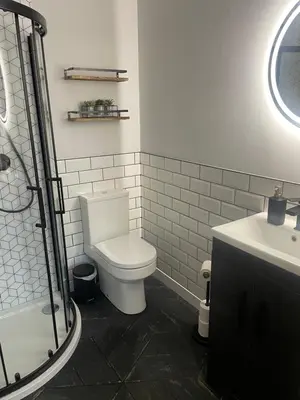 a bathroom with a toilet and a shower and a sink at Springlea in Oban