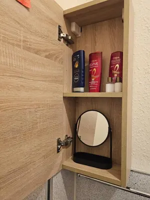 a wooden door with a mirror in a bathroom at Ocean View in Campbeltown
