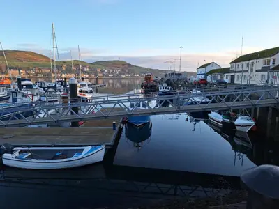 a group of boats are docked in a marina at Ocean View in Campbeltown