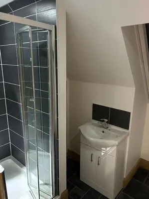 a bathroom with a sink and a glass shower at 101 Scotia Rooms in South Cobbinshaw