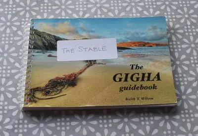 a book with the strka ghettica guidebook at The Stable at Drumachro in Isle of Gigha