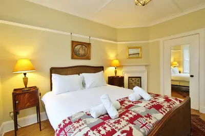 a bedroom with a bed with two towels on it at Elegant 3-Bedroom Ramsay Garden Apartment in Edinburgh City Centre in Edinburgh