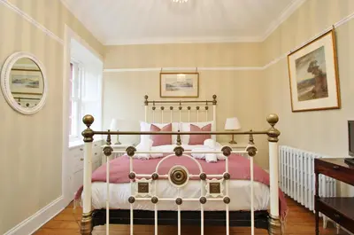 a bedroom with a large bed in a room at Elegant 3-Bedroom Ramsay Garden Apartment in Edinburgh City Centre in Edinburgh
