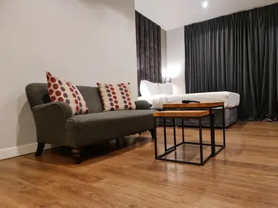 a living room with a couch and a table at VCity ApartHotels Glasgow Central in Glasgow