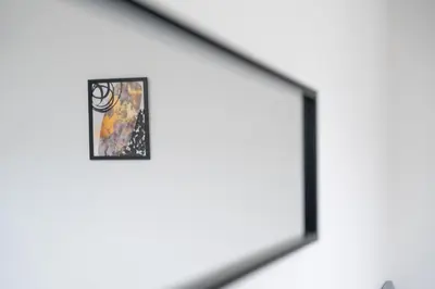 a framed painting on a wall in a room at Bell Apartment in Airdrie