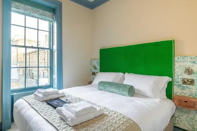 a bedroom with a bed with towels on it at Eleven Stafford Street Townhouse in Edinburgh