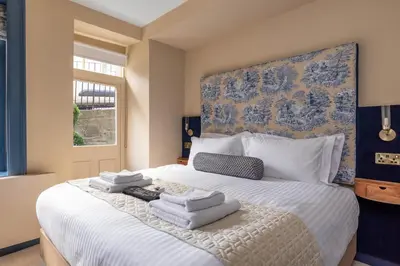 a bedroom with a large bed with towels on it at Eleven Stafford Street Townhouse in Edinburgh