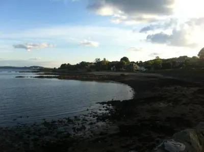 a view of a beach with the ocean and buildings at Aberdour Hotel, Stables Rooms & Beer Garden in Aberdour