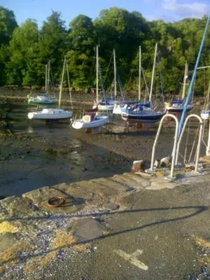 a group of boats sitting in the water at Aberdour Hotel, Stables Rooms & Beer Garden in Aberdour