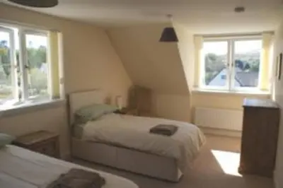 a bedroom with two beds and two windows at Glenview Salen in Salen