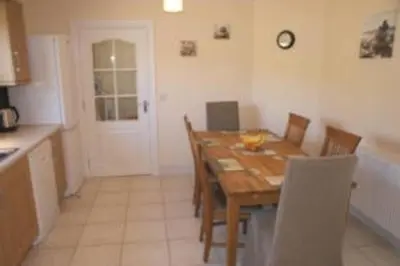 a dining room with a wooden table and chairs at Glenview Salen in Salen