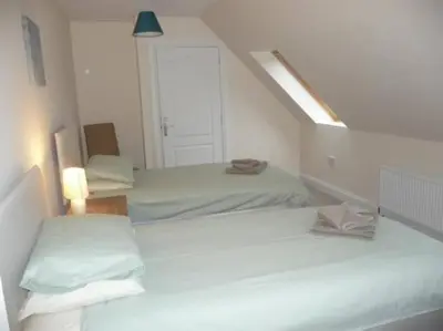 a white room with two beds and a window at Glenview Salen in Salen