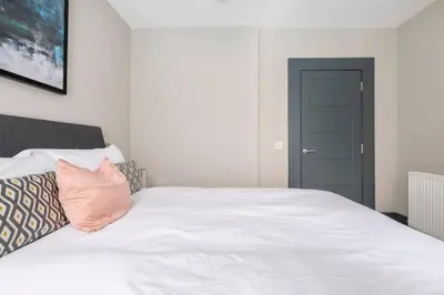 a white bed with pillows on it in a bedroom at Immaculate 3 Bed Apartment with Private Entrance in Inverleith in Edinburgh
