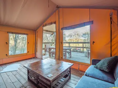 a living room with a couch and a table at Cobleland Campsite in Gartmore