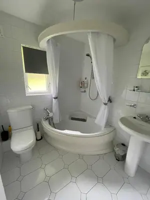a bathroom with a tub and a toilet and a sink at Gleneagles Rental in Auchterarder