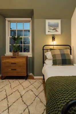 a bedroom with a bed and a window at The Old Deanston Workers Cottage in Doune