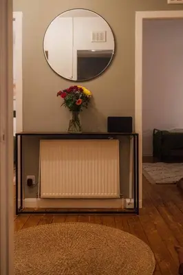 a vase of flowers sitting on top of a television at The Old Deanston Workers Cottage in Doune
