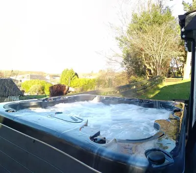 a jacuzzi tub with water in it at Stunning 7BR GardenVilla - Glasgow & Loch Lomond - Sleeps25 - PleasantHillScotland in Milngavie