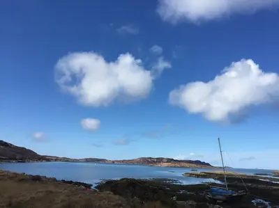 a large body of water with a boat in it at Rhumhor in Bunessan