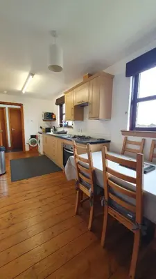 a kitchen with a table and two chairs in it at Rhumhor in Bunessan