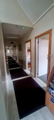 a hallway with rows of black mats on the floor at West Highland Lodge in Kinlochleven