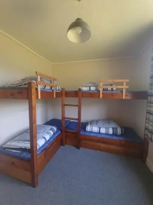 a room with three bunk beds in a room at West Highland Lodge in Kinlochleven