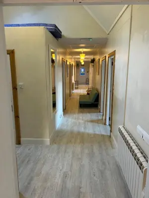 an empty hallway in a building with a long floor at West Highland Lodge in Kinlochleven