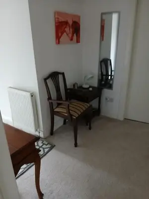 a room with two chairs and a table and a mirror at Couple's Retreat-West Kilbride in Seamill