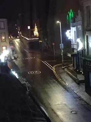 a city street at night with a christmas tree at Couple's Retreat-West Kilbride in Seamill