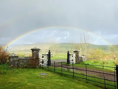 a rainbow over a gate with a fence at 2 Bed in Lochgilphead AG577 in Kilmartin