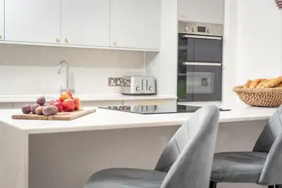 a kitchen with a counter with fruit on a cutting board at Stunning Dalchenna w/hot tub & huge garden in Stirling