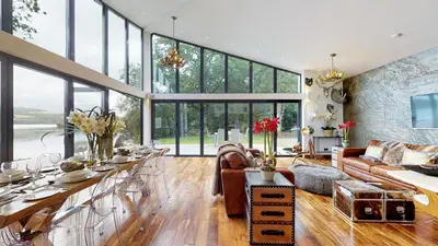 a living room with a large glass wall at Cameron North Lodge in Alexandria