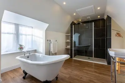 a white bath tub in a bathroom with a shower at Tarbert Country Manor in Tarbert