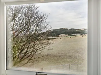 a window with a view of a field and a tree at 1 Bed in Dunning oc-ca333 in Dunning