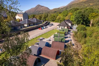an aerial view of a village with houses and mountains at Blackwater Glamping Pods in Kinlochleven