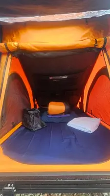 an inside view of an orange and blue tent at Blackwater Glamping Pods in Kinlochleven