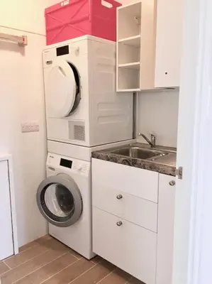 a small kitchen with a washing machine and a sink at Bremenvoir Barn in Bunessan
