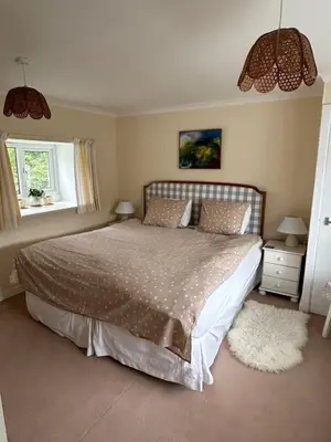 a bedroom with a large bed and a window at Ormsaig Byre in Beach