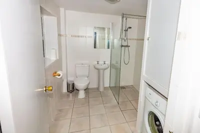 a bathroom with a toilet and a glass shower at Ormsaig Byre in Beach