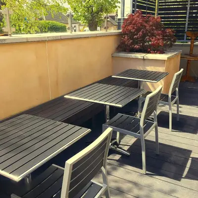 two picnic tables and chairs on a patio at The Parkville Hotel in Hamilton