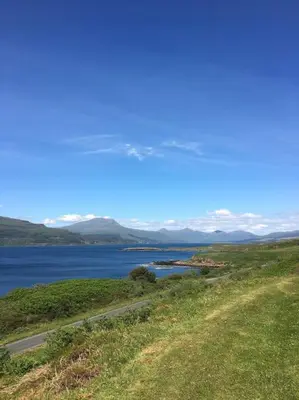 a view of a body of water with a road at Ormsaig Wooden Cottage in Burgh